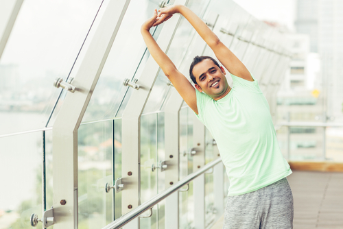 man stretching with moisture wicking shirt