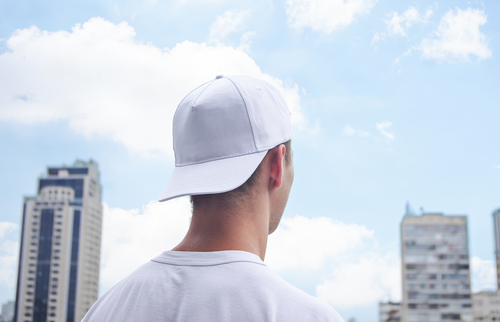 man wearing Yupoong hat