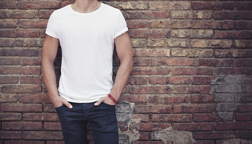 man wearing white t-shirt on brick wall background