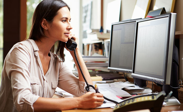 woman on business call taking notes