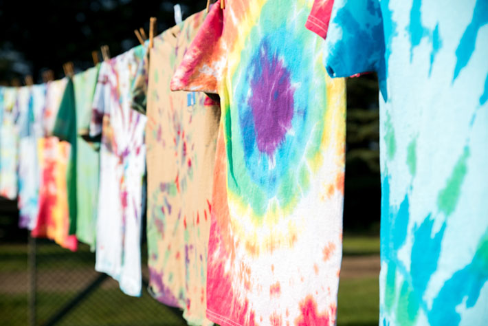 tie dyed shirts drying on line